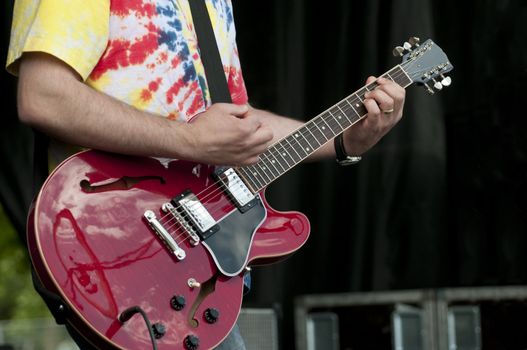 Selective focus on the cord hand of a muscian at a festival