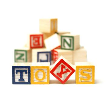 Alphabet blocks spell out the word toys with a touch of creativity.