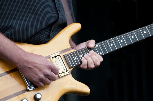 Musician playing the electric guitar at a local festival