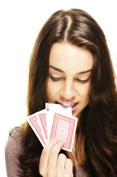 beautiful woman picks a poker card with her teeth on white background