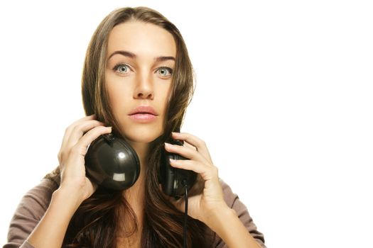 woman with headphones making big eyes on white background