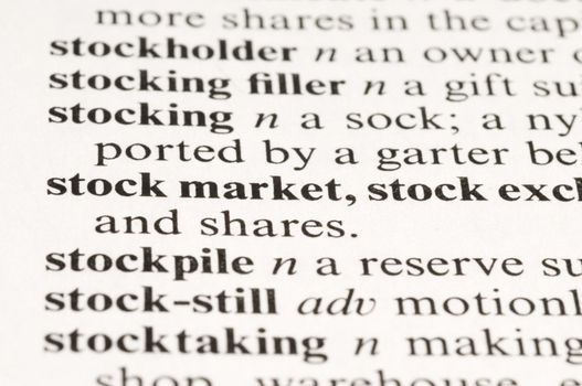 Macro image of a dictionary word "stock market" 