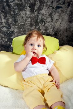 Little sweet gentleman sitting in red necktie.
