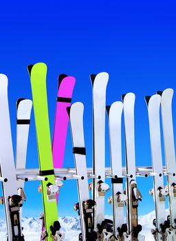 skis on snow covered place in winter with mountains in the distance