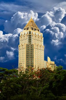 Golden high rise building against the blue sky