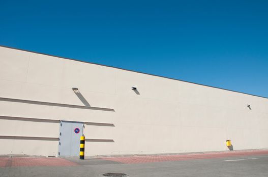 exterior view of a industrial warehouse building with a gorgeous blue sky