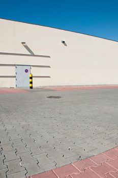 exterior view of a industrial warehouse building with a gorgeous blue sky