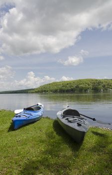 Two kayaks on the shoreline with the lake in the background