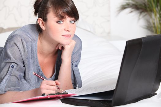 Young woman working at a laptop at home