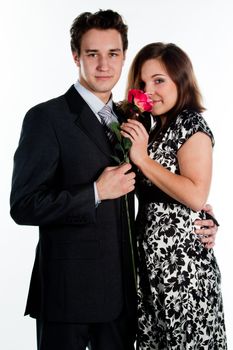 A young man gives a beautiful young woman, a flower in honor of the holiday