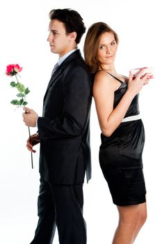 A young man gives a beautiful young woman, a flower in honor of the holiday