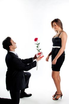 A young man gives a beautiful young woman, a flower in honor of the holiday