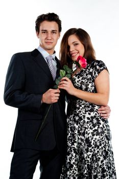 A young man gives a beautiful young woman, a flower in honor of the holiday