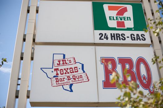 Outdoor sign displaying places in the plaza, in this case Seven-Eleven and JR Texas Barbecue.