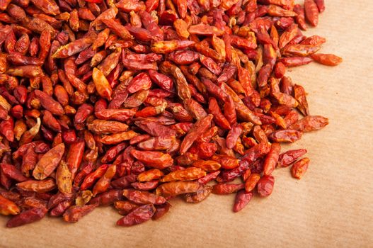 bunch of Piri Piri peppers on a brown background (close-up picture)