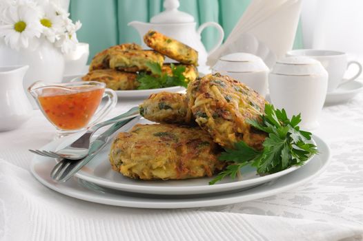 Potato pancakes with vegetables, sauce on the plate