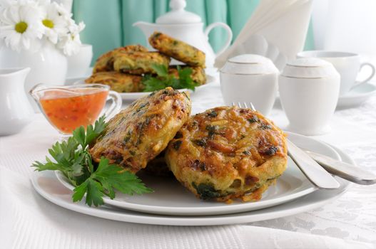 Potato pancakes with vegetables, sauce on the plate