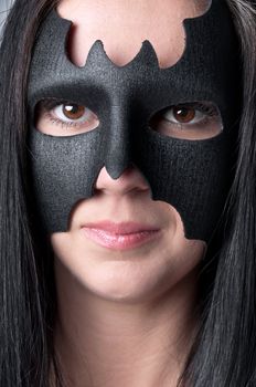 young and beautiful girl in the costume of a black bat