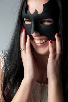young and beautiful girl in the costume of a black bat