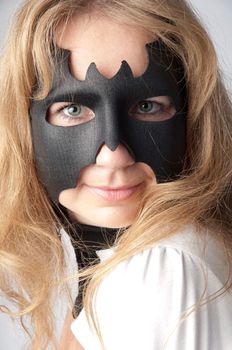 young and beautiful girl in the costume of a black bat