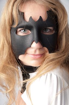young and beautiful girl in the costume of a black bat