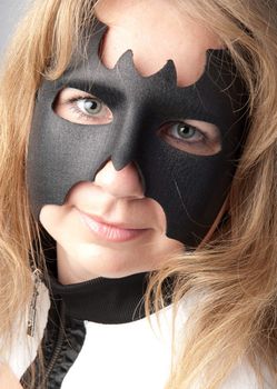 young and beautiful girl in the costume of a black bat