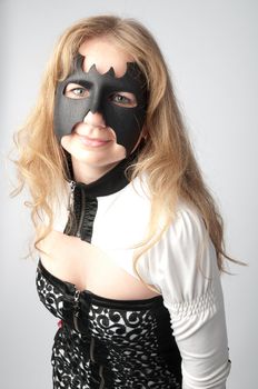 young and beautiful girl in the costume of a black bat