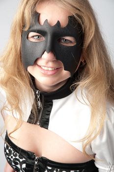 young and beautiful girl in the costume of a black bat