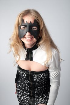 young and beautiful girl in the costume of a black bat
