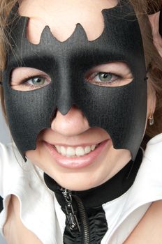 young and beautiful girl in the costume of a black bat