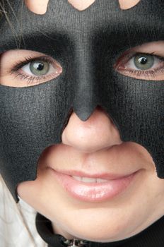 young and beautiful girl in the costume of a black bat