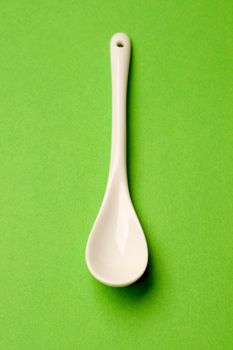 Spoon isolated on green background