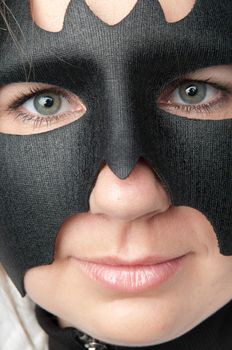 young and beautiful girl in the costume of a black bat