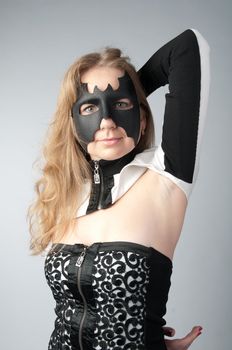 young and beautiful girl in the costume of a black bat