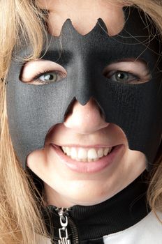 young and beautiful girl in the costume of a black bat