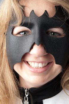 young and beautiful girl in the costume of a black bat