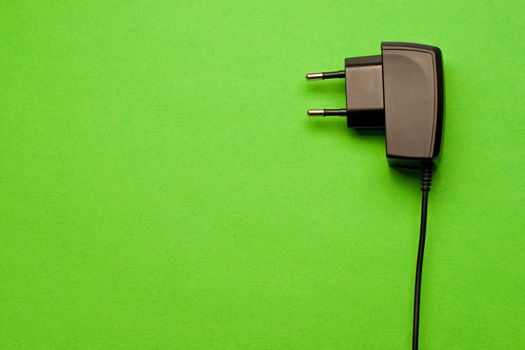 Electric plug isolated on the green background