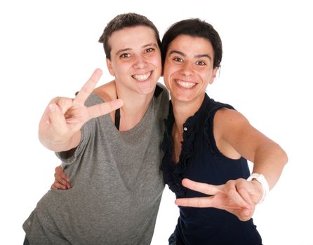 happy smiling sisters showing victory hand sign, isolated on white background