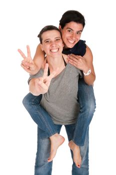 happy smiling sisters showing victory hand sign while playing together piggyback, isolated on white background