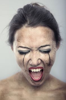Female vampire with burnt skin on a gray background. Artistic colors added