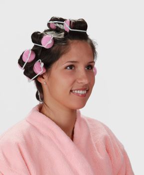 Portrait of a young woman with hair curlers on her head.
