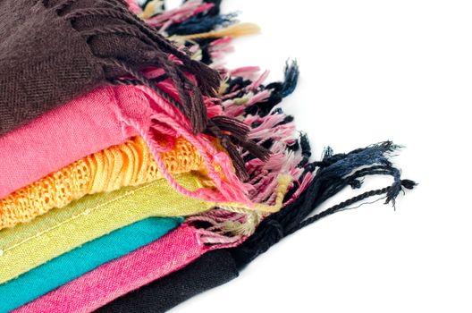 Pile of colorful scarves over white background.