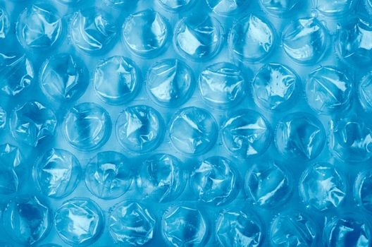 Blue Plastic bubble wrap pattern closeup.