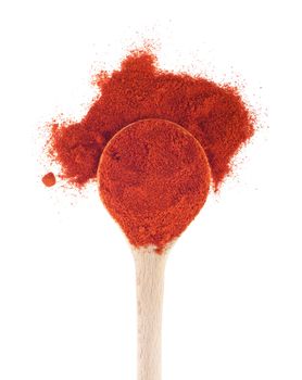 chili powder spice on a wooden spoon, isolated on white background