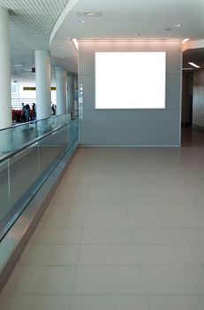 empty billboard and modern escalator at a international airport