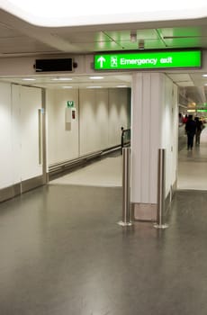 green emergency sign at a international airport corridor