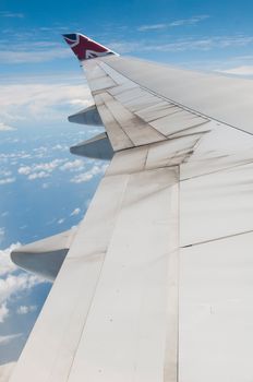 ST JOHNS, ANTIGUA - AUGUST 17: view of Boeing 747 wing of Virgin Atlantic Airways with blue sky clouds close to V. C. Bird International Airport in Antigua on August 17, 2011 in St. John's, Antigua