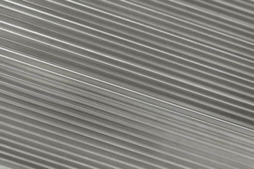 Silver metallic background containing diagonal running ridges