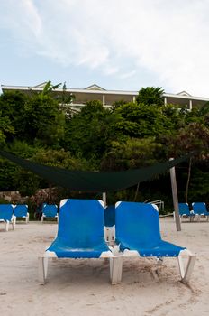 beach chairs on a tropical beach resort in Antigua (sunset picture)