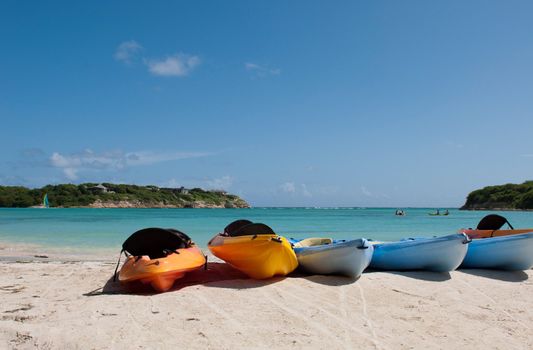 colourful kayaks on a white sandy beach, Long Bay in Antigua